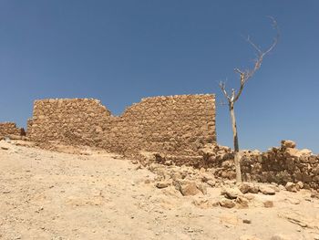 Scenic view of desert against clear blue sky