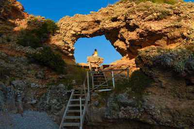 Low angle view of rock formation against sky