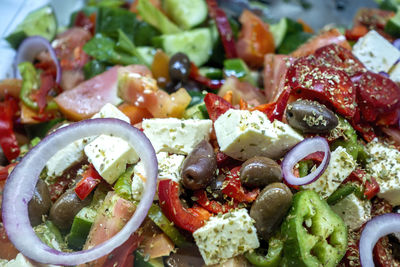 Close-up of chopped vegetables, cheese and olives marinated as a salad meal