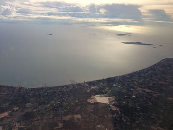 High angle view of townscape by sea against sky