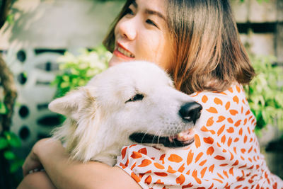 Close-up of smiling woman holding dog