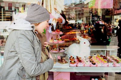 People at market stall in city