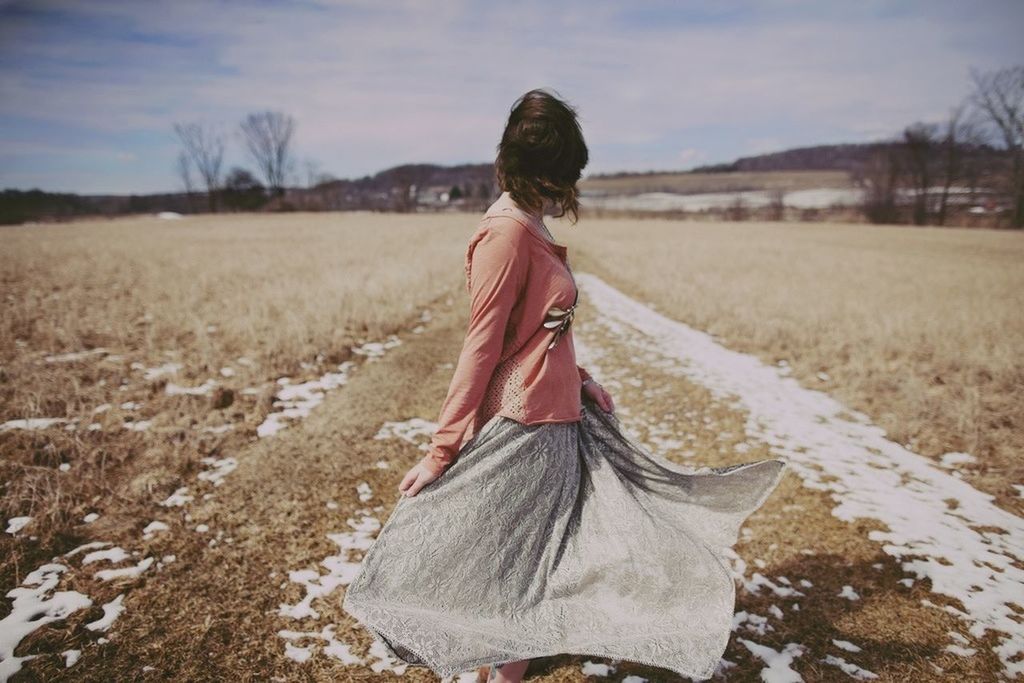 lifestyles, leisure activity, casual clothing, field, rear view, landscape, sky, full length, standing, grass, tranquil scene, tranquility, nature, beauty in nature, person, cloud - sky, rural scene, scenics