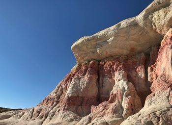 Low angle landscape of pink and white rock formations in colorado at paint mines interpretive park