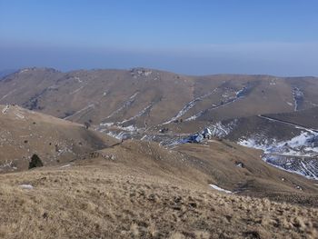 Scenic view of desert against clear blue sky