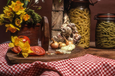 Food by vase on wooden table