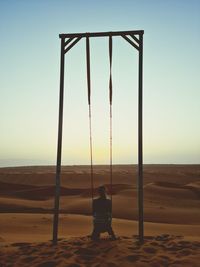 Scenic view of woman sitting over a desert