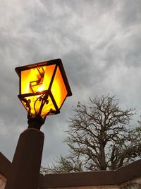 Low angle view of illuminated street light against sky