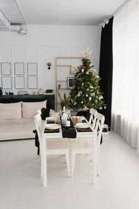 Festive set dining table in the living room in black and white colors on the background