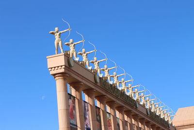 Low angle view of traditional building against clear blue sky