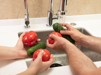 Cropped hands of woman holding bell pepper