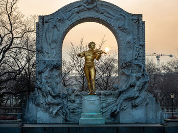 Low angle view of angel statue against sky