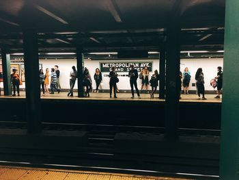 People standing on railroad station platform