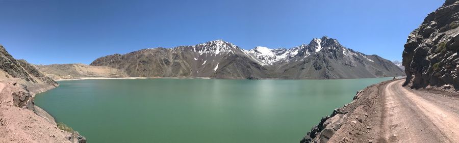 Panoramic view of snowcapped mountains against clear blue sky