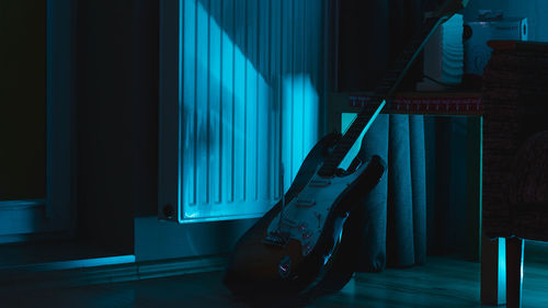 Guitar in darkroom at home