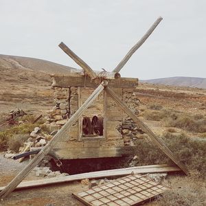 Metallic structure on land against sky