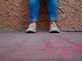 Low section of woman walking on road