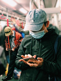 Full length portrait of man holding mobile phone