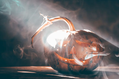 Close-up of burning candle on table