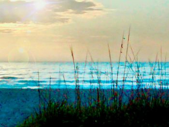 Scenic view of sea against sky at sunset