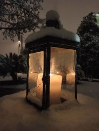 Close-up of illuminated lamp at night during winter