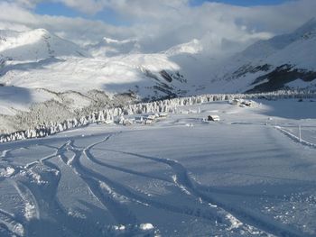 Snow covered landscape against sky