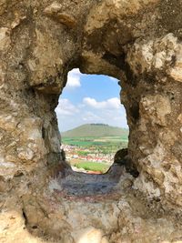 Scenic view of rock formation seen through hole