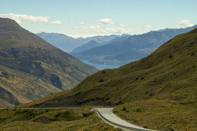 Highway pass across the mountain range to famous queenstown on a beautiful sunny day.