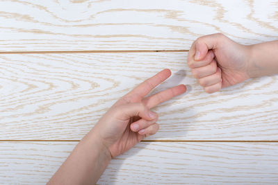 Cropped hands gesturing on table