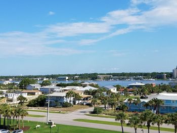 High angle view of town by sea against sky