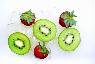 Close-up of green fruits on white background