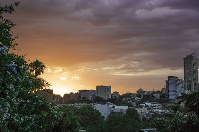 Panoramic view of cityscape against dramatic sky