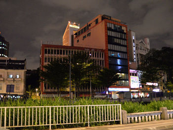 Buildings against sky at night