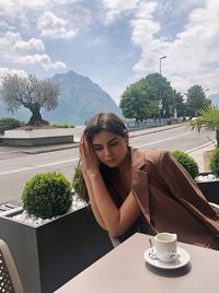 Young woman sitting on table