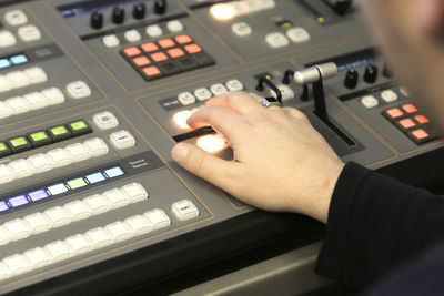 Cropped hand mixing music in recording studio