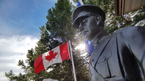 Low angle view of statue against trees