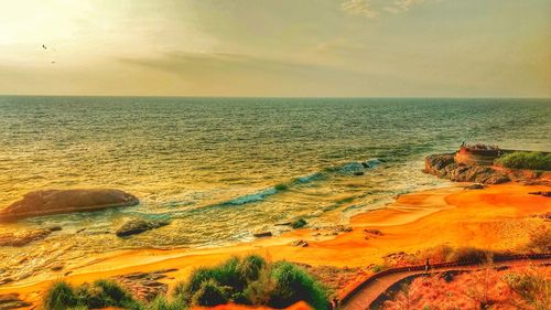 Scenic view of beach at sunset