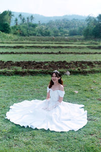 Woman in a gown on field