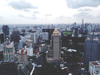 Skyscrapers against cloudy sky