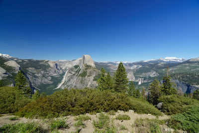 Scenic view of mountains against clear blue sky