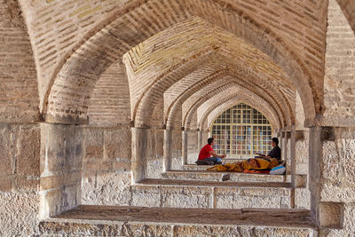 People sitting in old building