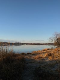 Scenic view of lake against clear blue sky