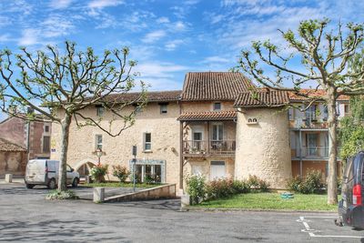 Residential buildings by street against sky