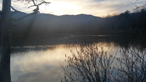 Scenic view of lake at sunset