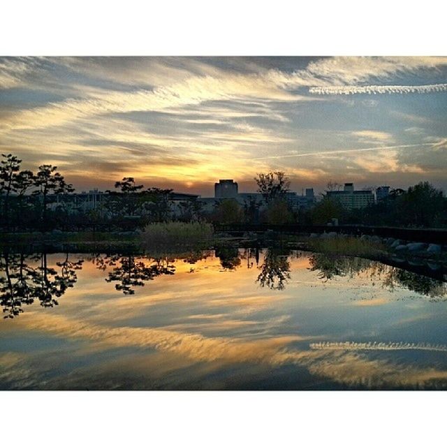 sunset, water, reflection, sky, transfer print, lake, tranquil scene, tranquility, scenics, waterfront, silhouette, beauty in nature, auto post production filter, built structure, cloud - sky, architecture, nature, orange color, river, standing water