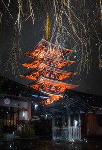 Low angle view of illuminated buildings in city at night