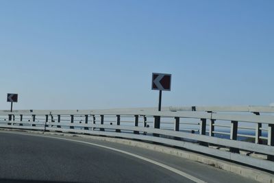 Road against clear blue sky