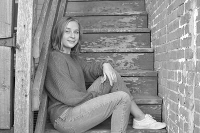 Portrait of smiling young woman sitting on seat