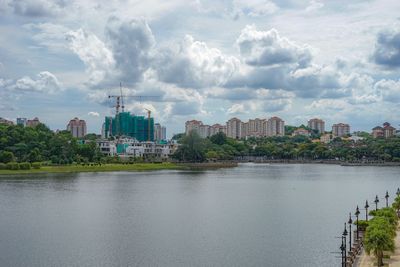 River by buildings in city against sky