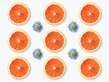 Close-up of orange slices against white background